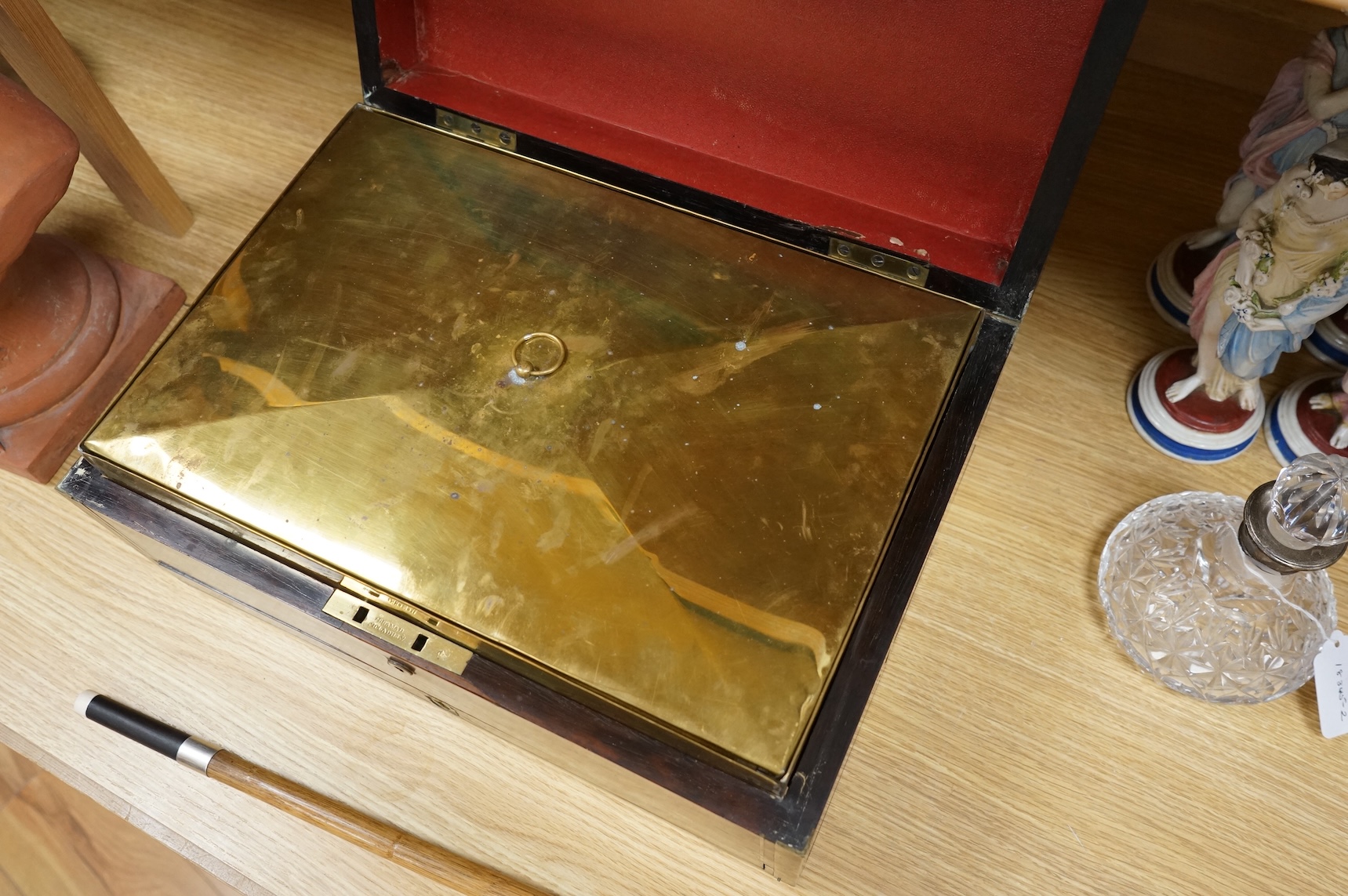 A Regency brass bound mahogany travelling tobacco box, coat of arms to centre, the inner brass cover with cedar wood lining 42.5cm wide